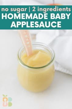 a jar filled with homemade baby applesauce sitting on top of a white table