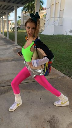 a woman in neon colored tights is posing for the camera with her hand on her hip