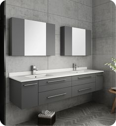 a bathroom with two sinks and mirrors on the wall