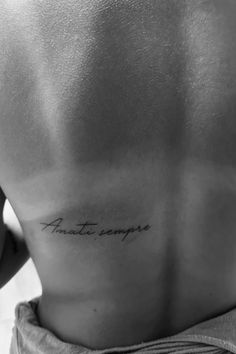 the back of a man's stomach with an inscription on it