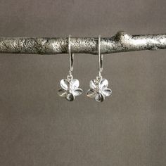 "⇩CLICK BELOW FOR DETAILS⇩ ✦Plumeria flower charms are cast from sterling silver and dangle from sterling silver lever back ear wires. The flowers measure about 10mm in diameter (about 3/8 inch) and have a total length of about 1 inch. So lightweight and easy to wear. Also available with sterling silver French hook ear wires. Please select the ear wire style at check out. ✦Also available with sterling silver hoop ear wires: https://www.etsy.com/listing/520153457 ✦Matching necklace available: htt Tiny Sterling Silver Flower Earrings, Delicate Tiny Sterling Silver Flower Earrings, Minimalist Sterling Silver Flower Charm Earrings, Silver Flower Earrings With Lever Back Ear Wires, Sterling Silver Flower Charm Earrings For Everyday, Sterling Silver Earrings With Flower Charm For Everyday, Silver Sterling Flower Earrings With Lever Back, Sterling Silver Flower Earrings, Hawaiian Flower