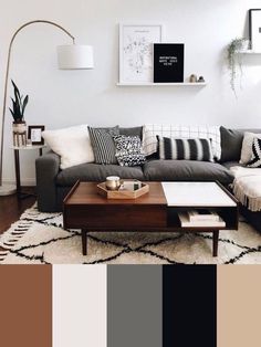 a living room with black and white furniture, rugs and pictures on the wall