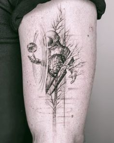 a man's leg with a tattoo on it that has an image of a person holding