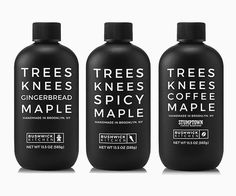 three bottles of tree's knees ciderbread maple syrup on a white background