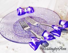 a plate with purple bows and a fork on it