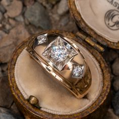 a diamond ring sitting on top of a wooden box