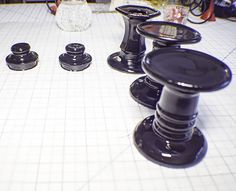 several black knobs are sitting on a white counter top next to some other items