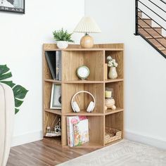 a bookshelf in the corner of a living room next to a stair case