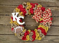 a wreath with the letter k and football on it sitting on top of a wooden table