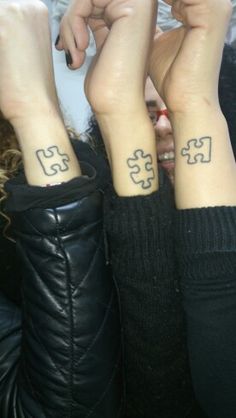 two people with matching tattoos on their arms