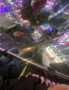 people are looking down at the carnival from an observation point on a ferris wheel ride