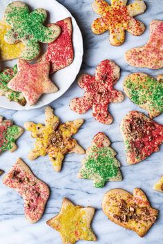 christmas cookies are arranged on a marble table