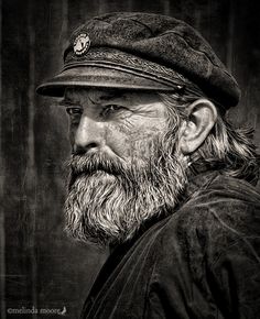 an old man with a beard wearing a hat