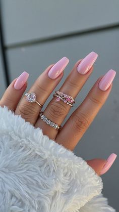 a woman's hand with pink manies and rings