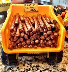 a yellow tray filled with hot dogs on top of a counter