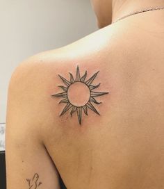 a woman with a sun tattoo on her back