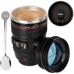 a camera lens and spoon next to a coffee cup with lid on the side, set against a white background