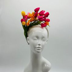 Handmade by Featured Milliner of The Kentucky Derby Museum 2023 & 2024! Spring has sprung! This is the perfect spring piece! Beautiful dark pink, yellow and light pink tulips with pops of green. Can be worn on either side! Attaches with headband.  Not taking customs this year--Derby 150 is going to be massive and mom life keeps me running! However, happy to suggest pieces that will coordinate with your outfit. If you don't love the way this attaches to your head--message me!  I can swtich *most* pieces to your preference. Clip, Headband OR Elastic Cord  NOTE: Heavier pieces with extravagant florals etc require the stability of a headband. NO RETURNS/EXCHANGES due to nature of product (special occasion and head wear). Not all screens/lighting are created equal. Make sure you are happy with Multicolor Spring Headband, Multicolor Headband For Spring, Pink Spring Fascinator With Structured Crown, Pink Fascinator With Structured Crown For Spring, Pink Structured Crown Fascinator For Spring, Pink Spring Headpiece With Structured Crown, Spring Pink Headpiece With Structured Crown, Pink Structured Crown Headpiece For Spring, Spring Races Fascinator With Pinched Crown