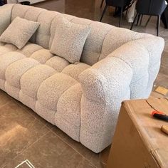 a couch that is sitting on the floor in a room with other items around it