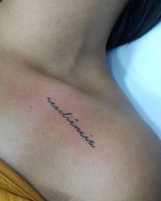 a woman's chest with the word love written in cursive writing on it