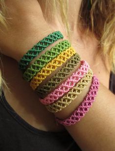 a woman wearing bracelets made from crocheted yarn