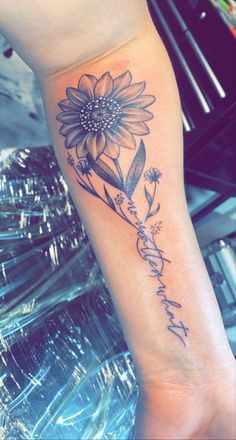 a woman's arm with a sunflower and the words, i love you in cursive writing