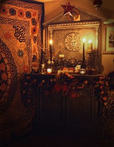 a room with a table, rug and candles