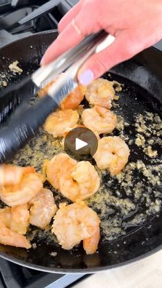 someone is frying shrimp in a skillet on the stove