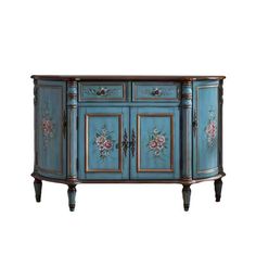 a blue cabinet with flowers painted on the doors and drawers, sitting against a white background