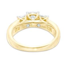 a yellow gold engagement ring with three diamonds