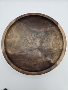 a wooden bowl with wavy lines on it