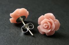 Two pretty pinkish peach colored resin gardenia flowers have been set on a pair of silver plated post earrings (no nickel) to create handmade flower earrings that come with a set of matching silver plated earring backs. Flower Size: 12mm These earrings come in a variety of colors! http://etsy.me/1rEclsO Stop by and visit http://stumblingonsainthood.etsy.com to see more handmade designs! © Stumbling On Sainthood (StumblingOnSainthood@gmail.com) www.StumblingOnSainthood.com Shop Policies - http:// Pink Flower Earrings With Rose Design, Rose Flower Earrings For Pierced Ears, Peach Pink, Pink Earrings, Rose Earrings, Handmade Design, Earring Backs, Silver Studs, Handmade Flowers