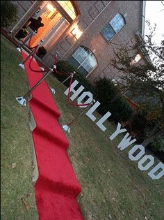 a red carpeted walkway leading up to a brick building with the words hollywood on it