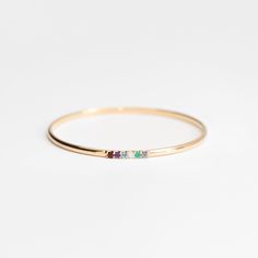 The Stacked Birthstone is a unique style customized to your story. Choose 3-6 natural gemstones in a secure and stunning prong setting on a solid 14k gold bangle. A 3x2mm solid 14k half-round bangle with 3-6 shared prong set natural gemstones.To find your perfect fit, please order our set of sizing bangles first. Gemst 14k Gold Stackable Bangle Fine Jewelry, Stackable 14k Gold Fine Jewelry Bangle, Stackable 14k Gold Bangle Fine Jewelry, Stackable 14k Gold Bangle In Fine Jewelry Style, 14k Gold Gemstone Bangle, 14k Gold Bangle With Gemstone, 14k Gold Gemstone Bangle Fine Jewelry, 14k Yellow Gold Gemstone Bangle, Stacked Bangles