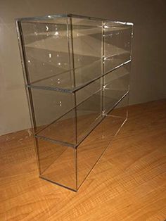 a glass display case sitting on top of a wooden floor