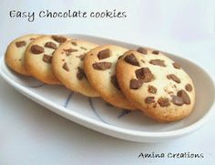 three chocolate chip cookies on a plate with the words easy chocolate cookies written above them