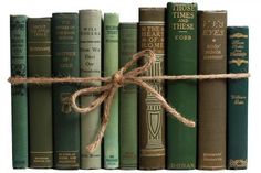 a bunch of books tied up to each other with a brown string on top of them