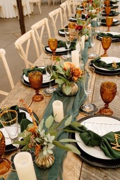 the table is set with place settings, candles and napkins for dinner guests to enjoy