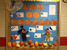 a bulletin board decorated with pumpkins and scarecrows