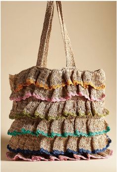 a handbag made out of crocheted yarn with ruffles on it