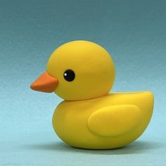 a yellow rubber duck sitting on top of a blue surface