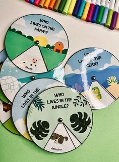 four children's book discs with the words who lives in the jungle? written on them