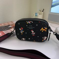 Printed Coated Canvas And Smooth Leather Two Credit Card Slots Inside Multifunction Pocket Zip Closure, Fabric Lining Outside Open Pocket Detachable Strap With 22 3/4" Drop For Shoulder Or Crossbody Wear 7 1/2" (L) X 5 1/4" (H) X 2 1/4" (W) Disney X Coach Disney Style No. Cn027 Trendy Rectangular Bags For Disney Trips, Coach Disney, Disney Bag, Holiday Prints, Disney Style, Christmas List, Coach Bags, Smooth Leather, 4 H