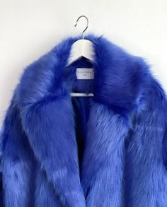 "Royal Blue, Indigo Blue Oversize Fur Coat. Luxury, fluffy fabric, very soft. 100% polyester. Handmade made in London, UK.  Oversize style. Big collar. Long sleeves. Metal snap buttons (invisible) Two side pockets. Lenght 82cm - 1cm) Handmade in UK.  Model wears size S.  HOW TO CHOOSE A SIZE ?   Using a measuring tape, measure your bust, waist and hips (widest part) and compere with size chart.  SIZE CHART: (CM) B: Bust  H: Hips  XS - B: 83-88 cm  H: 90-95 cm  S - B: 88-93 cm H: 95-100 cm  M - B: 93-98 cm H: 100-105 L - B: 103-108 cm  H: 105-110 cm XL - B: 108-113 cm H: 110-115 cm CARE INSTRUCTIONS: Dry clean only, do not wash, do not iron, do not bleach.  Please message me before purchasing so I can check availability. If you wish this fur in any other colour, shorter or longer \"send mes Blue Fur Outfit, Luxury Fur Coat, Grammy Performance, Oversized Fur Coat, Blue Fur Coat, Blue Faux Fur Coat, Festival Coats, Fur Outfit, Fluffy Fabric