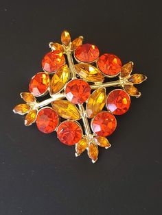 Vintage Edlee Orange Rhinestone Maltese Cross Brooch Pin This brooch sparkles with the colors of the Fall season with shades of orange rhinestones set into shiny gold tone metal in the shape of a Maltese cross. Brooch measures 2 1/2 inches by 2 1/2 inches and has a secure pin back closure. Signed ©EDLEE on the back of the brooch. In excellent vintage condition. Visit my shop at JanesVintageJewels.etsy.com Cross Brooch, Maltese Cross, Rhinestone Bracelet, Cool Necklaces, Rhinestone Brooches, Shades Of Orange, Pin Backs, Vintage Yellow, Maltese