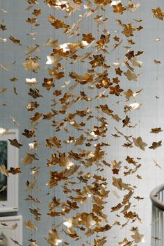 a group of gold leaves hanging from the ceiling