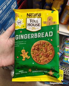 a hand holding a bag of toll house gingerbread cookies in front of a store shelf