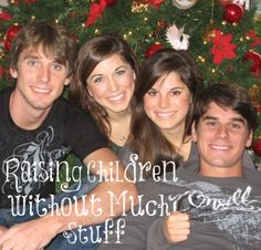 a group of young people sitting next to each other in front of a christmas tree