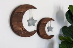 two wooden moon and star decorations hanging on the wall