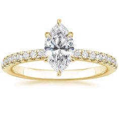 a yellow gold engagement ring with a pear shaped diamond in the center and side stones